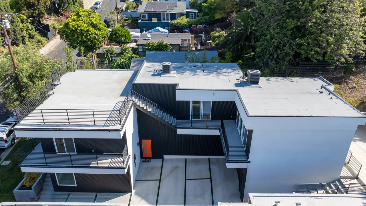Aerial view over the home's rooftop decks and courtyard