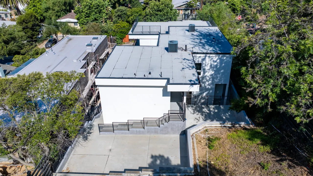 Aerial view of the home on its hillside lot