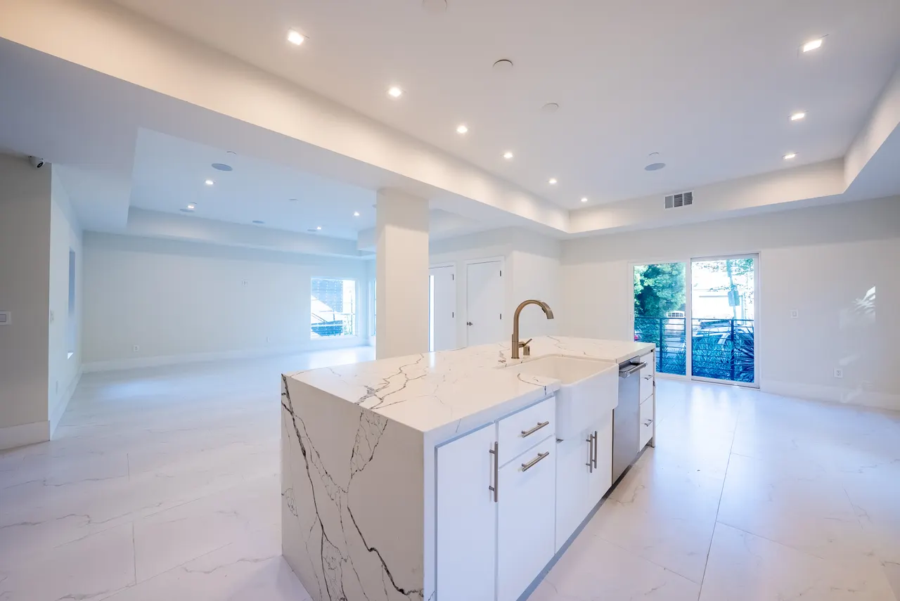 Great room with a waterfall marble island and abundant natural light